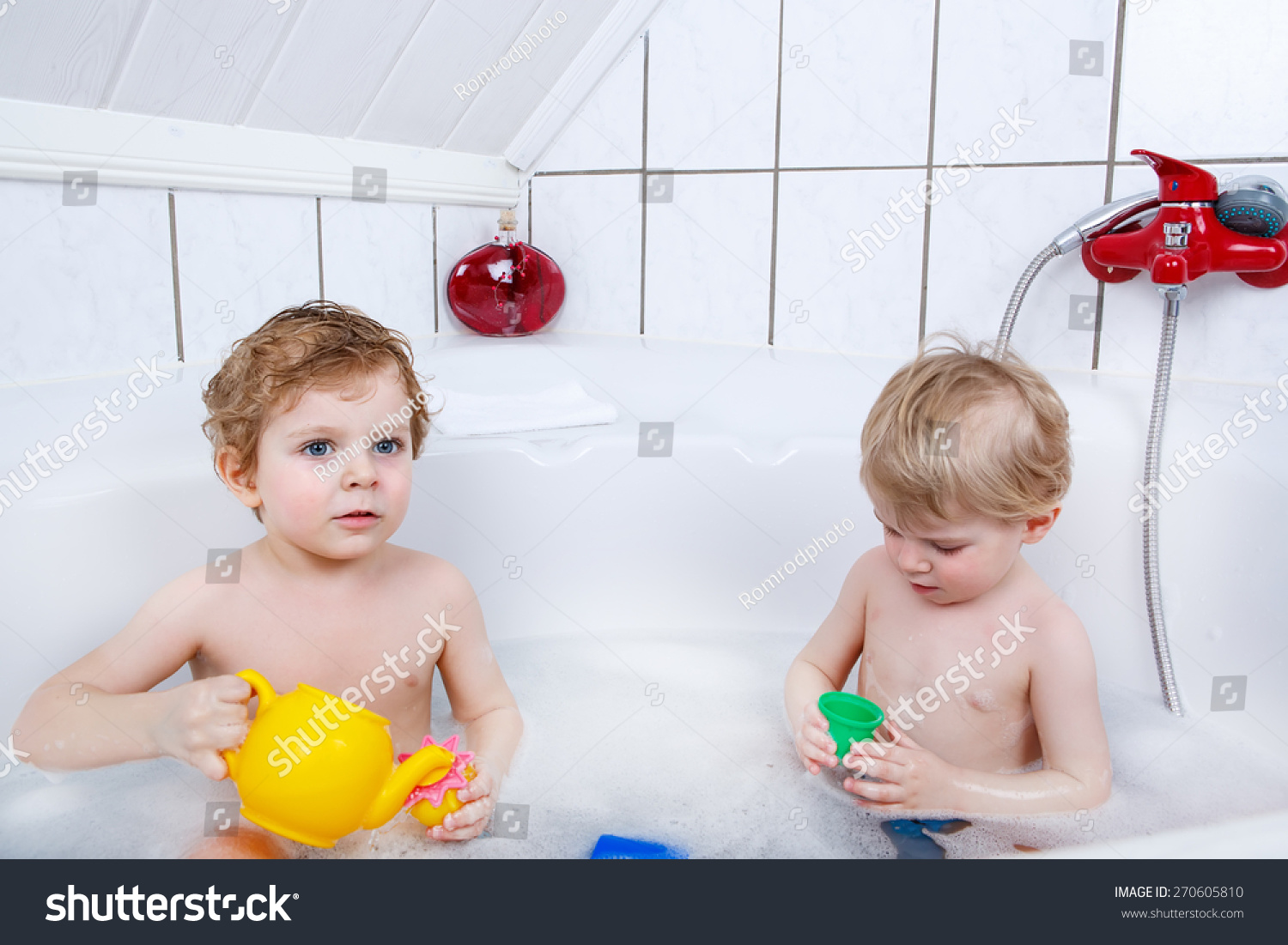 Two Little Friends Boys Having Fun With Water By Taking Bath In Bathtub
