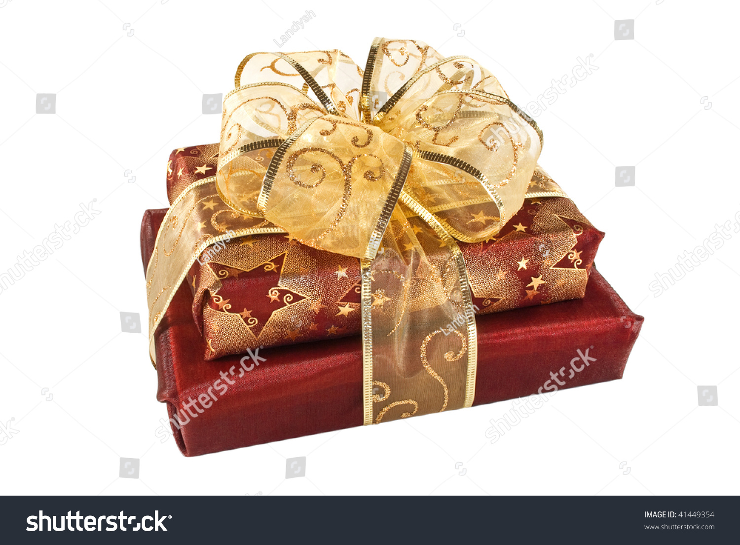 Two Wrapped Red Gift Boxes Decorated With Golden Ribbon And Bow