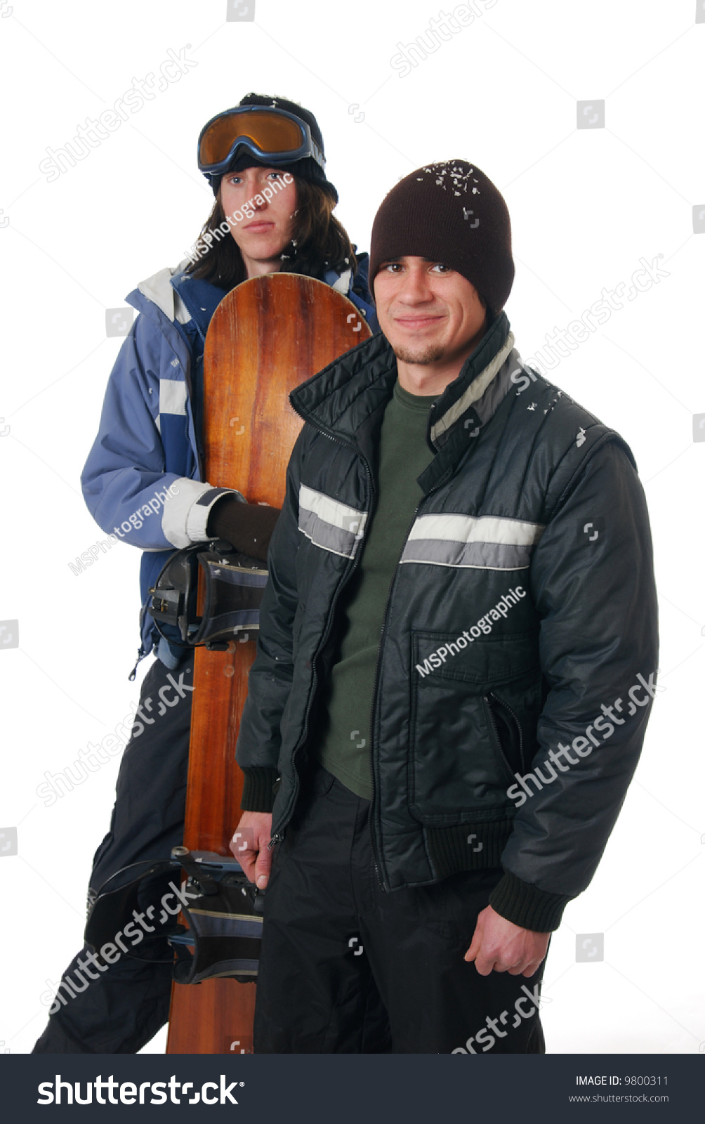 Two Young Men In Winter Coats With A Snowboard Stock Photo 9800311