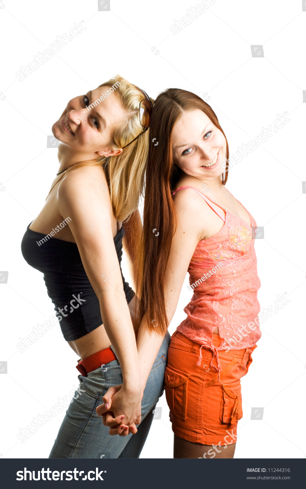 Two Young Women Standing Back To Back. Isolated. Stock Photo 11244316 