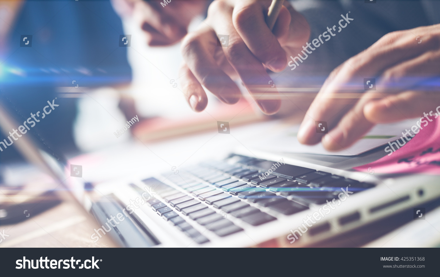 Typing on laptop Meeting report in progress Film effect blurry background and lens flare effect Typing on laptop Meeting report in progress Film effect blurry background and lens flare effect