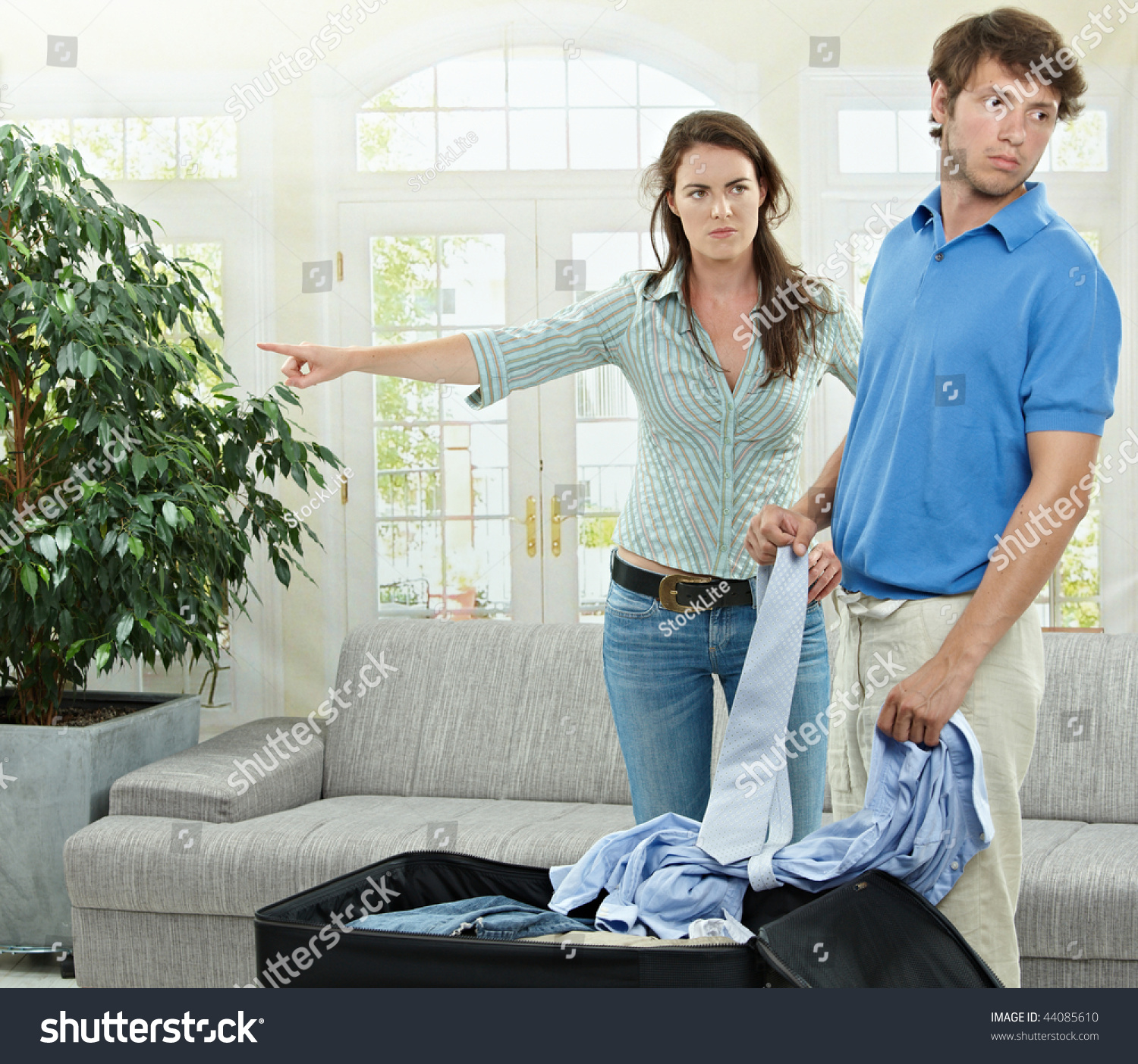 Unhappy Couple Breaking Angry Woman Pointing Out Man Packing His Clothes Into Suitcase Stock 3683