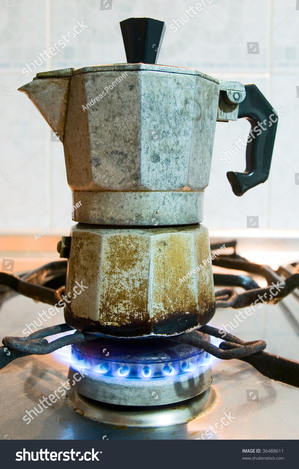 Used Italian Coffee Maker Above A Gas Flame In The Kitchen Stock Photo