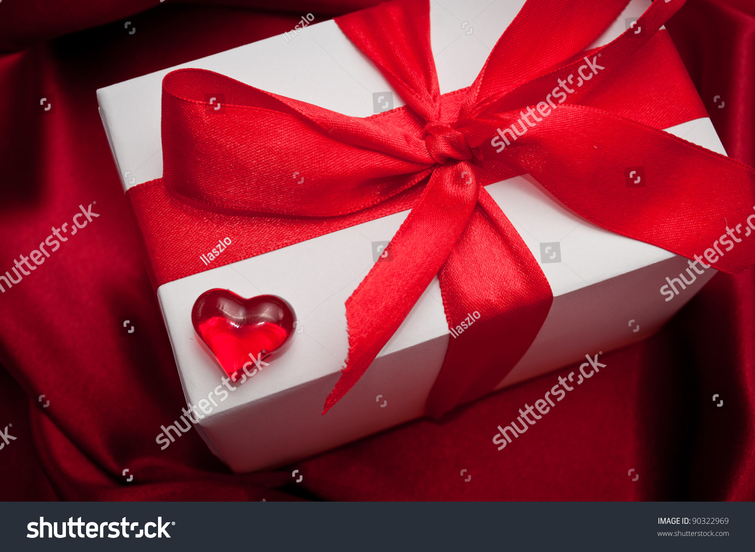 Valentines Gift Boxes Tied With A Red Satin Ribbon Bow On Red Satin