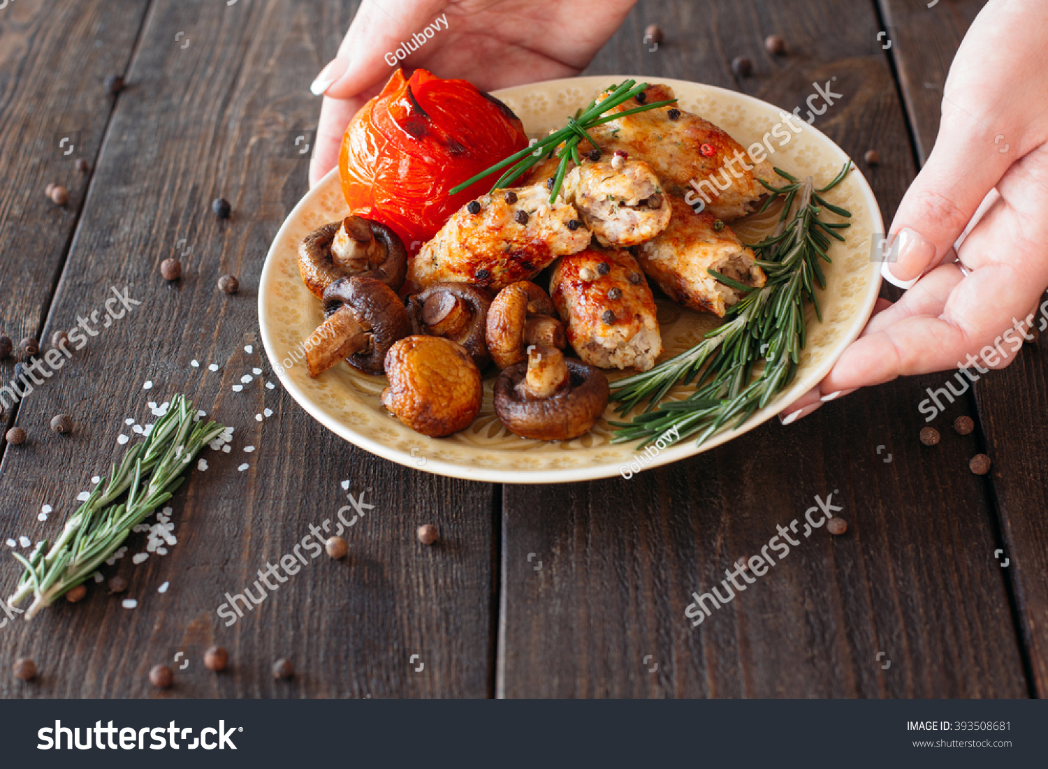 Waiter serving a shish kebab with tomato and mushrooms. chief ...