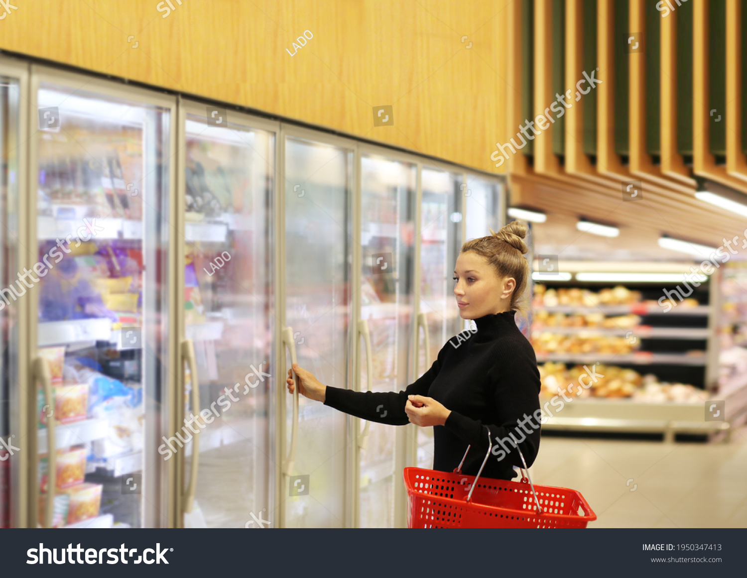 Woman Choosing Frozen Food Supermarket Freezer Stock Photo