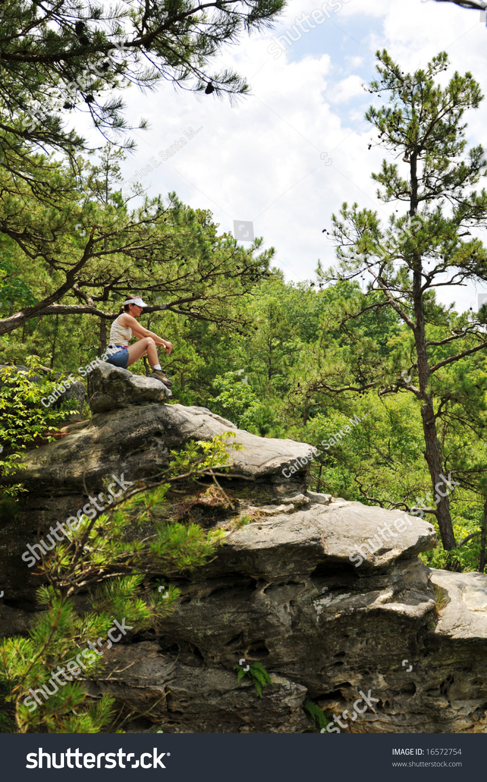 Woman Hiker Sitting On A Rock And Enjoying The View Stock Photo