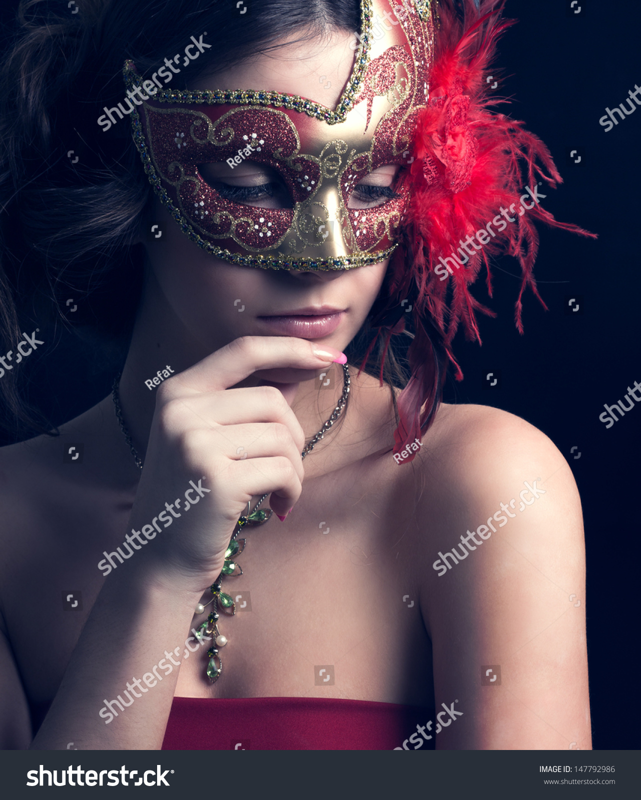 Woman In Masquerade Mask On A Black Background. Stock Photo 147792986