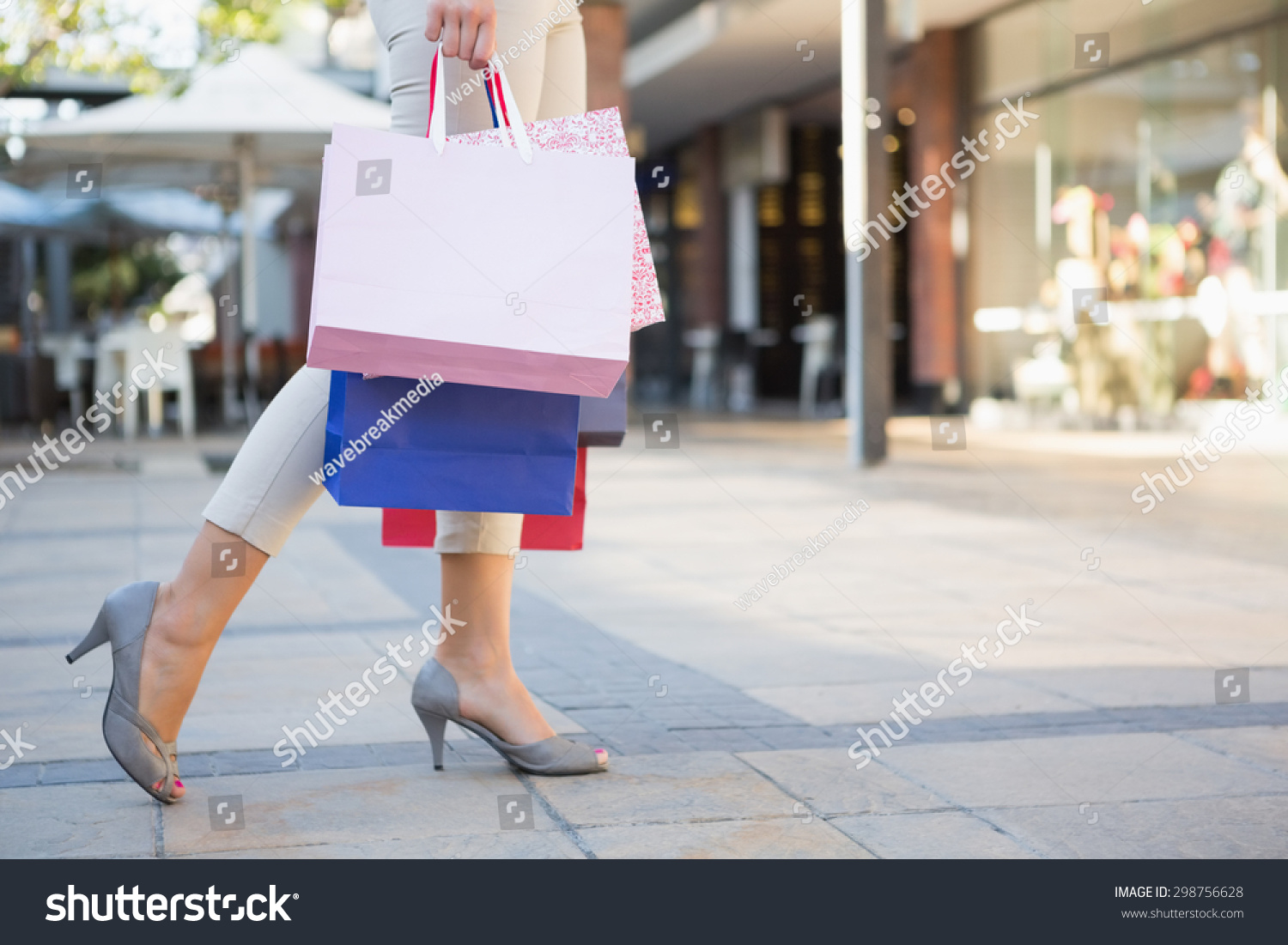 Woman Walking With Shopping Bags At The Shoppingmall Stock Photo