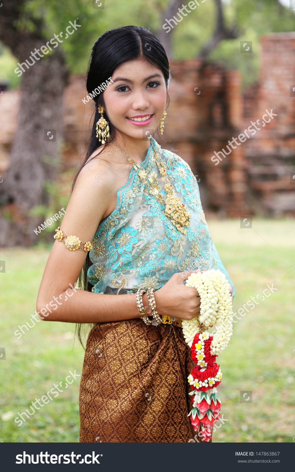 Woman Wearing Typical Thai Dress With Thai Style Temple Background