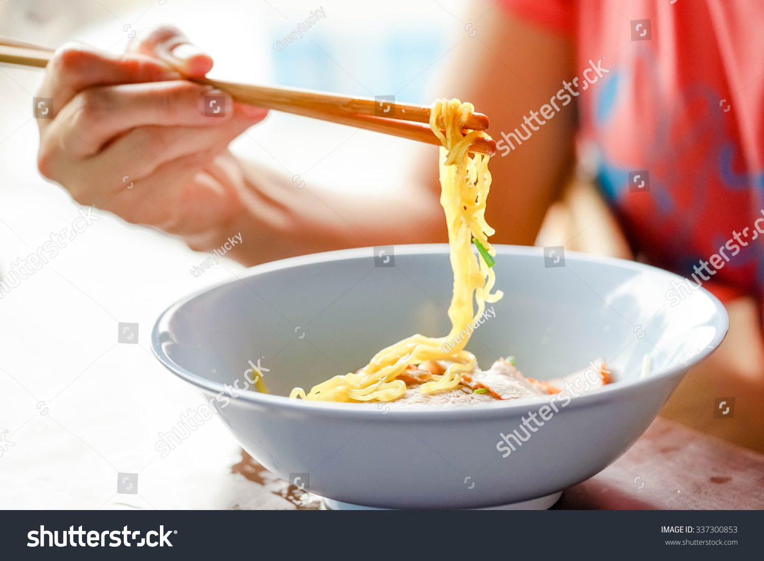 women using chopsticks eating noodle women using chopsticks eating noodle