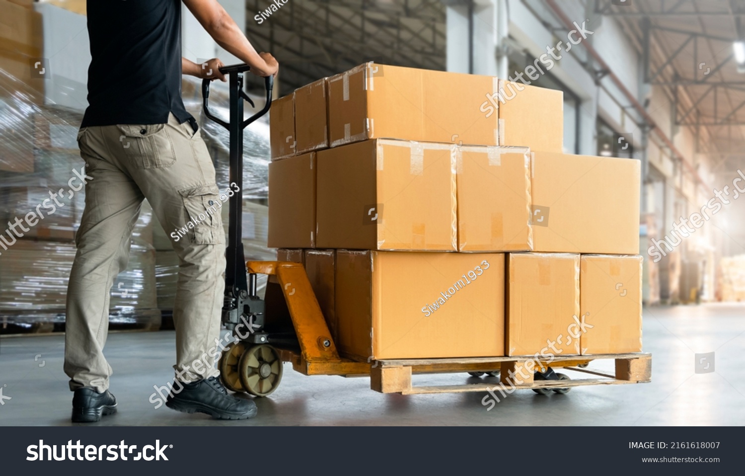 Workers Unloading Packaging Boxes On Pallets Stock Photo