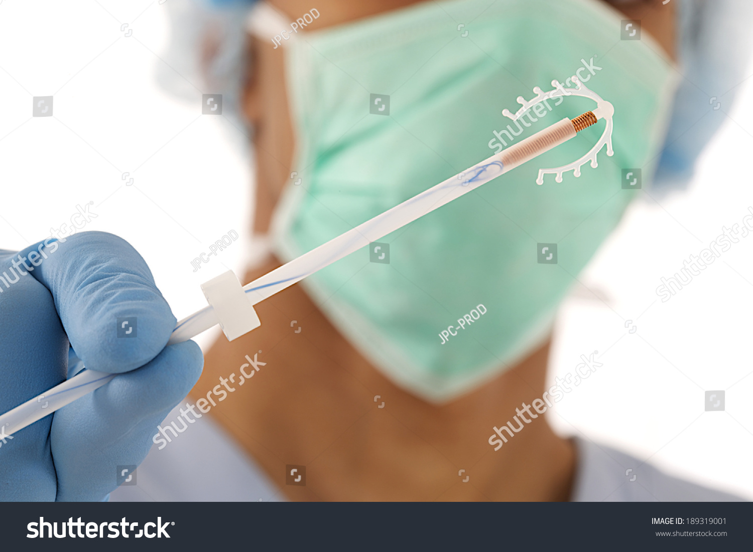 yound-doctor-holding-an-iud-birth-control-copper-coil-device-in-hand