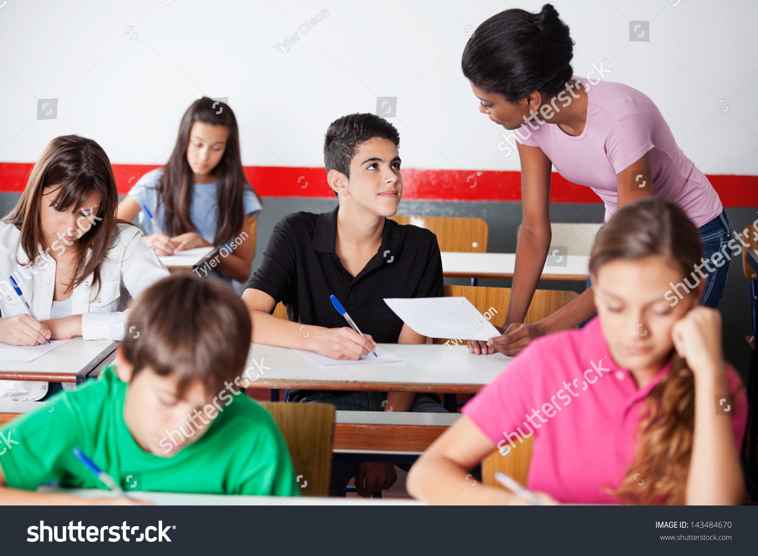 Young African American Teacher Assisting Teenage Stock Photo 143484670 