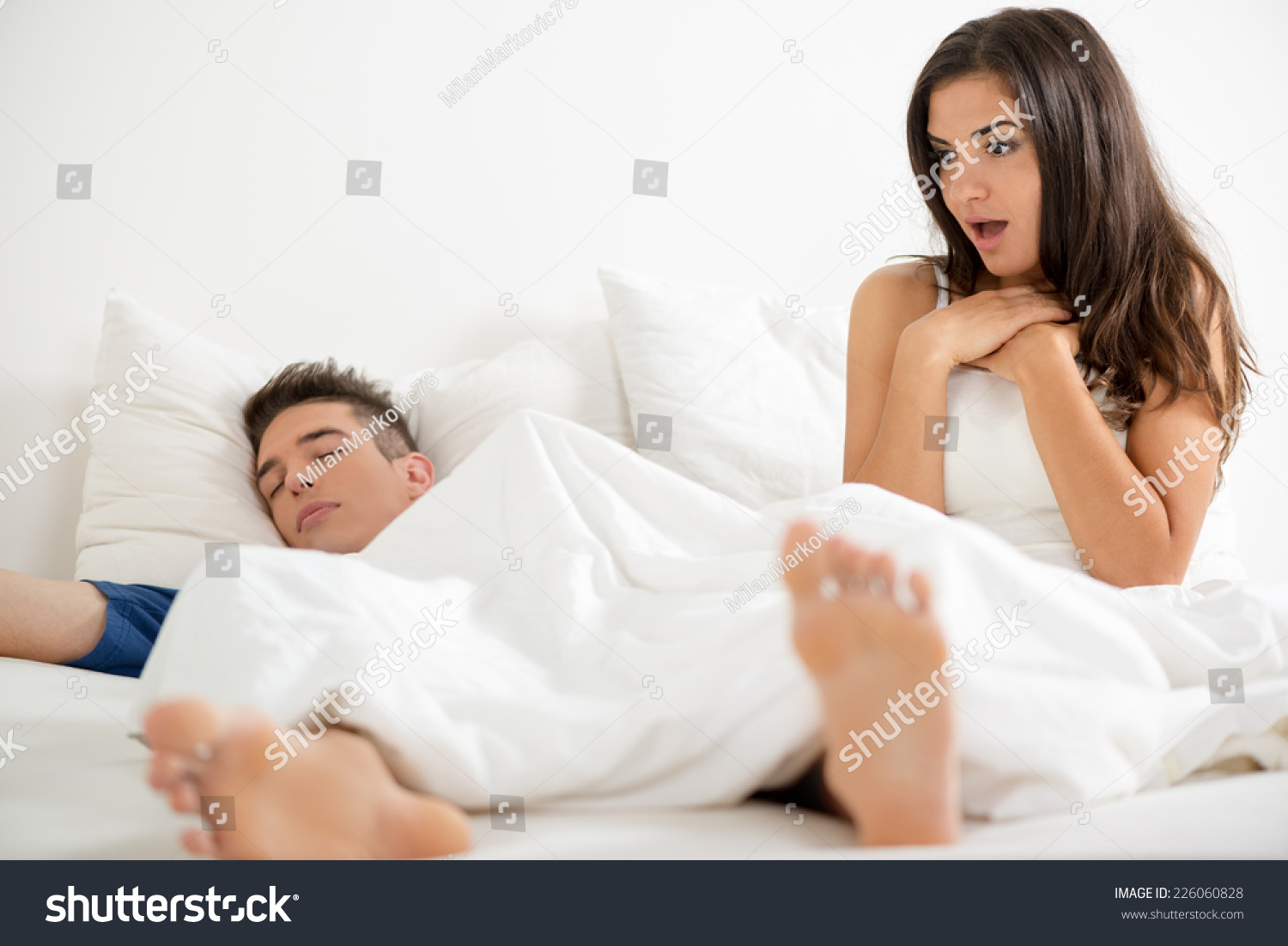 Young Attractive Girl After Waking Up In Bed Looking With Surprise