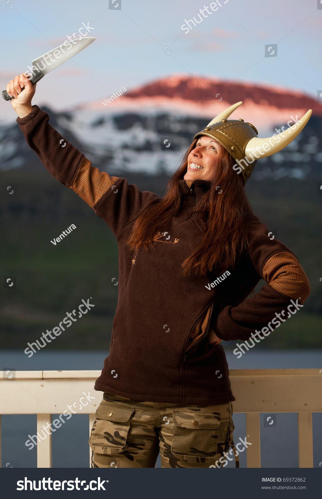 Young Attractive Woman With Nordic Helmet Posing With Knife Stock Photo