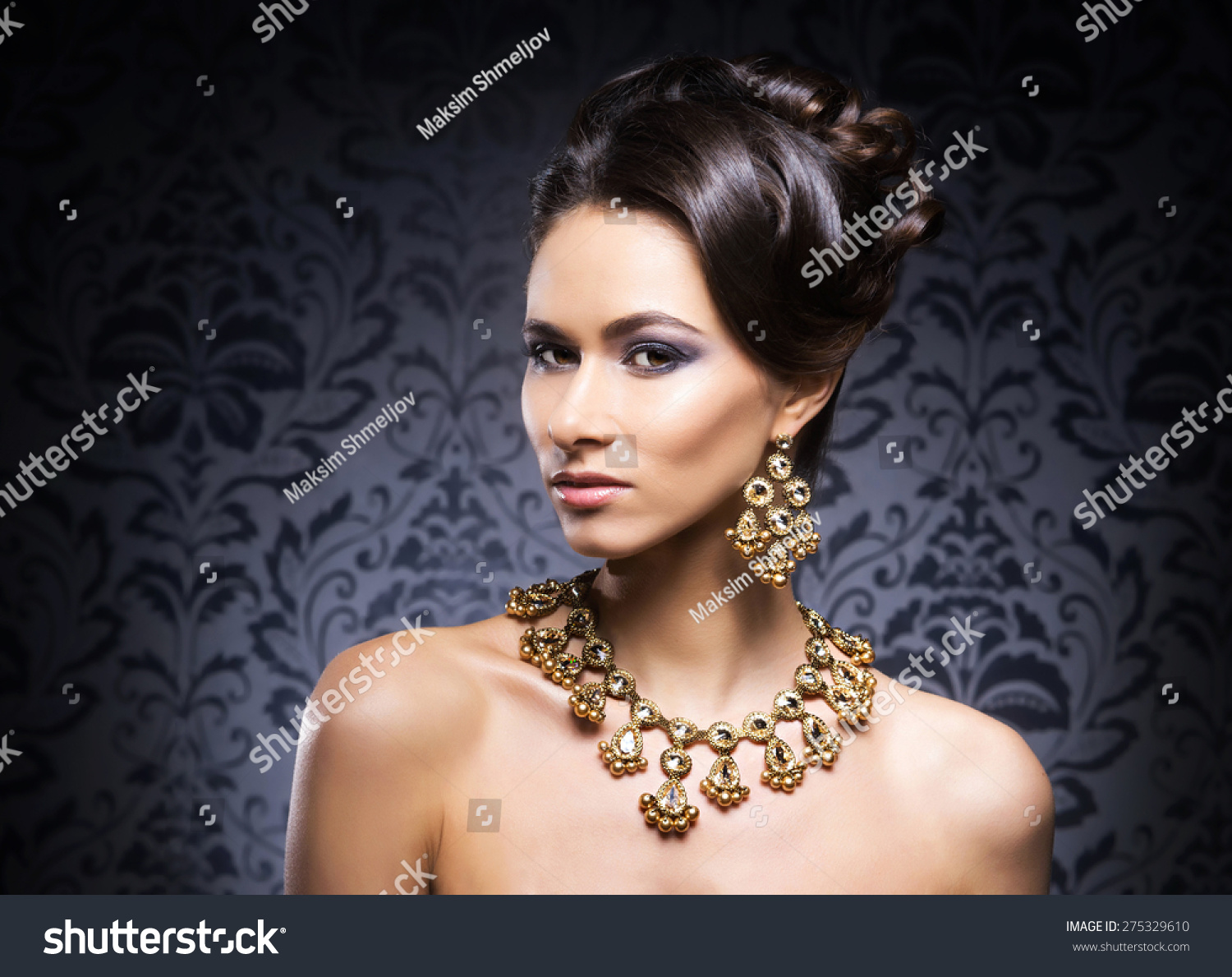 Young Beautiful And Rich Woman In Jewels Of Gold And Stones Over