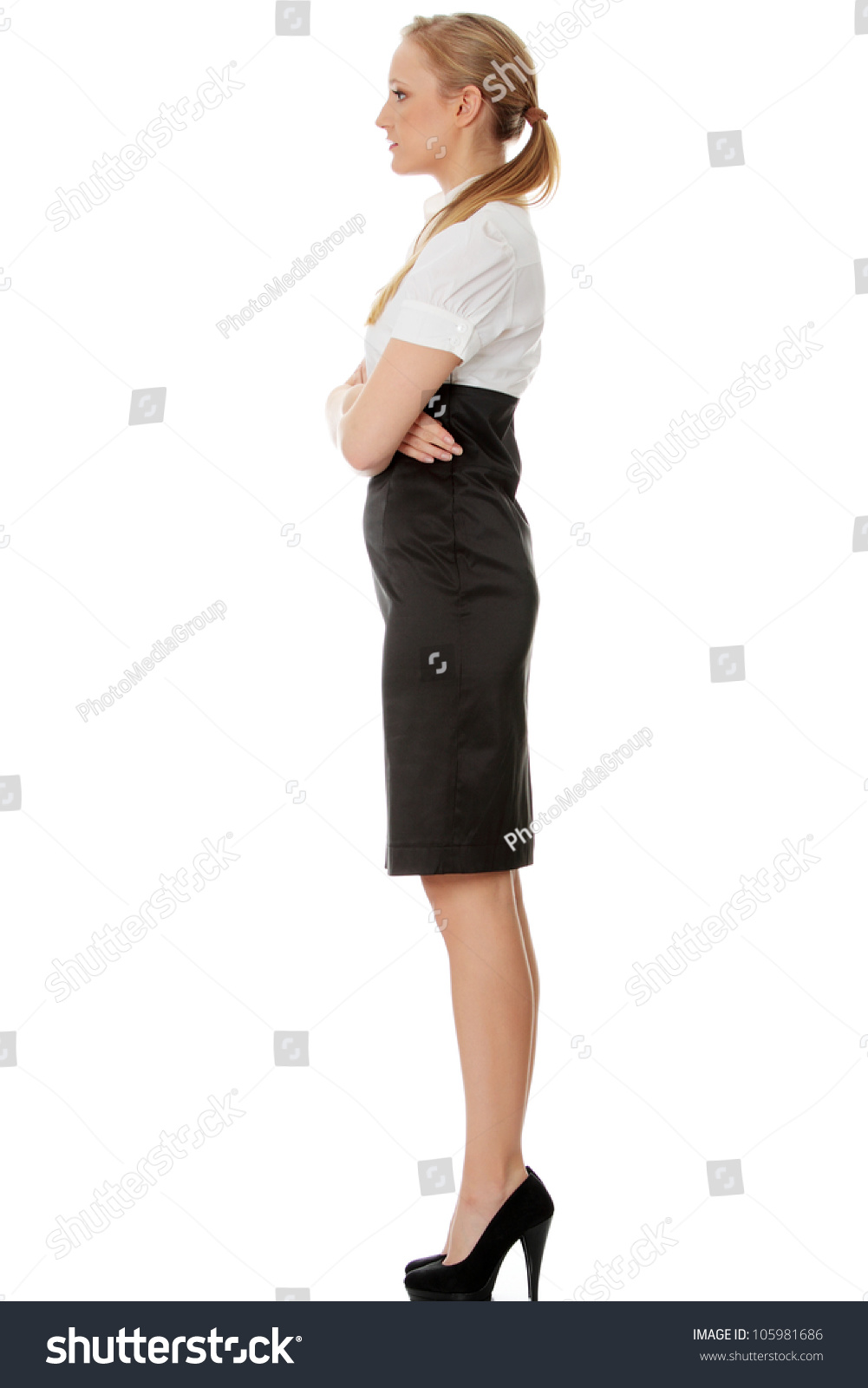 Young Beautiful Elegant Businesswoman Is Standing Sideways With Crossed