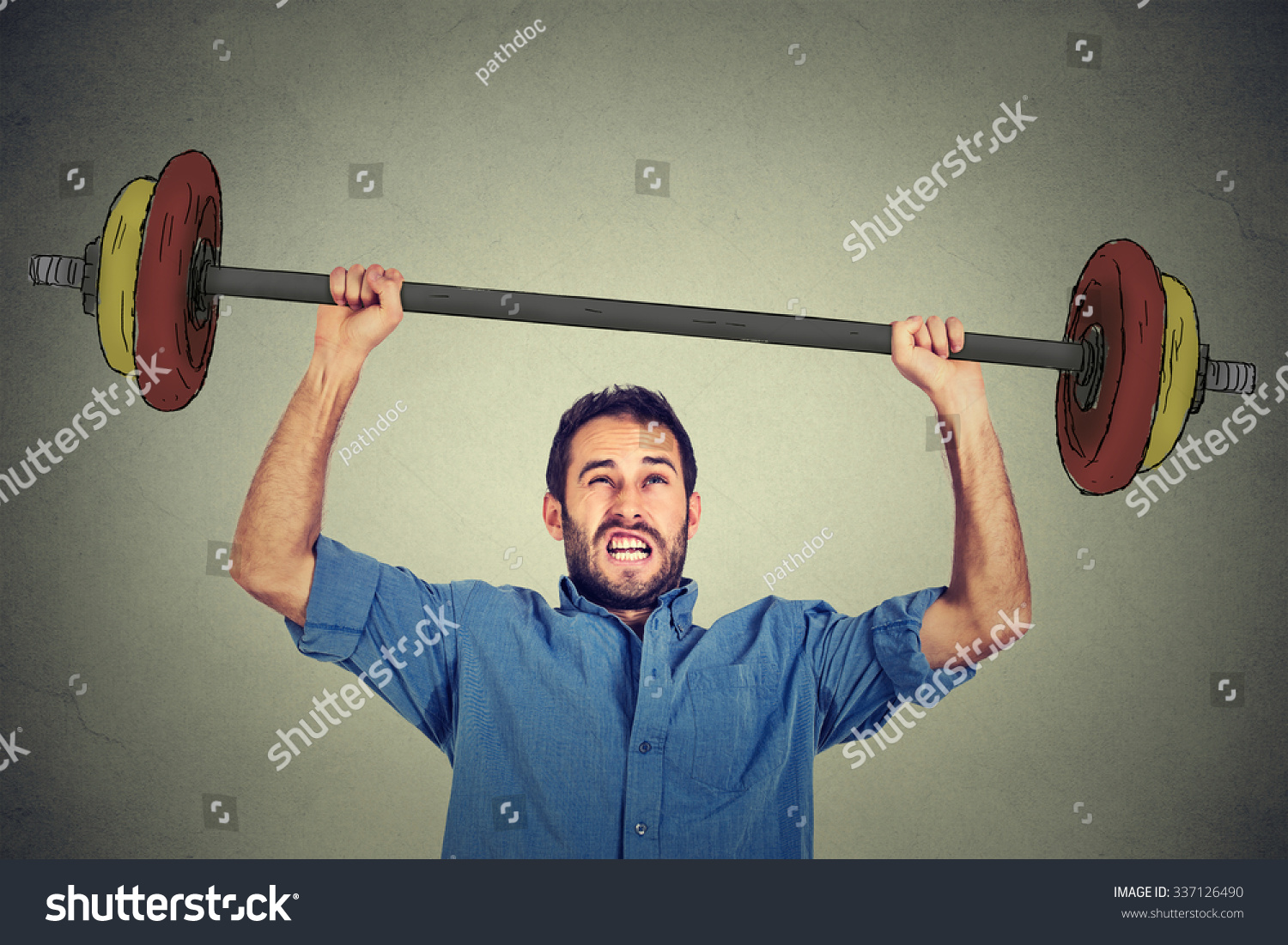 young-business-man-trying-to-lift-very-heavy-weight-stock-photo