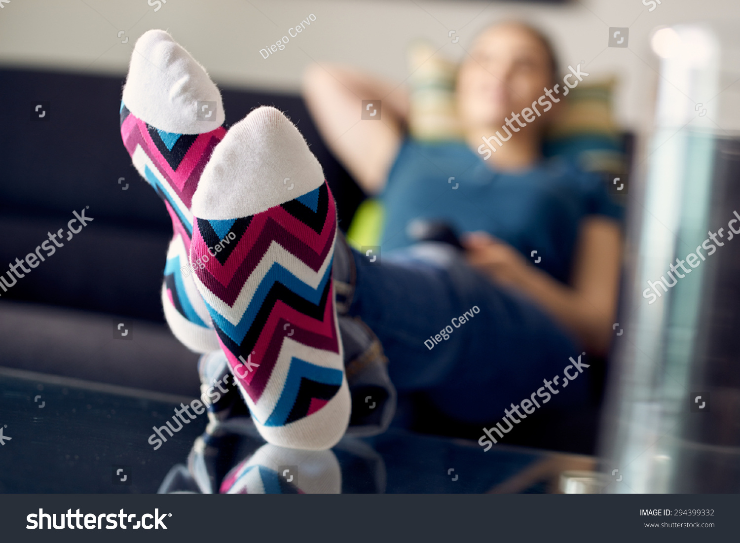 Young Caucasian Woman Laying On Sofa With Colourful Socks She Puts Her Feet On Table And 4687