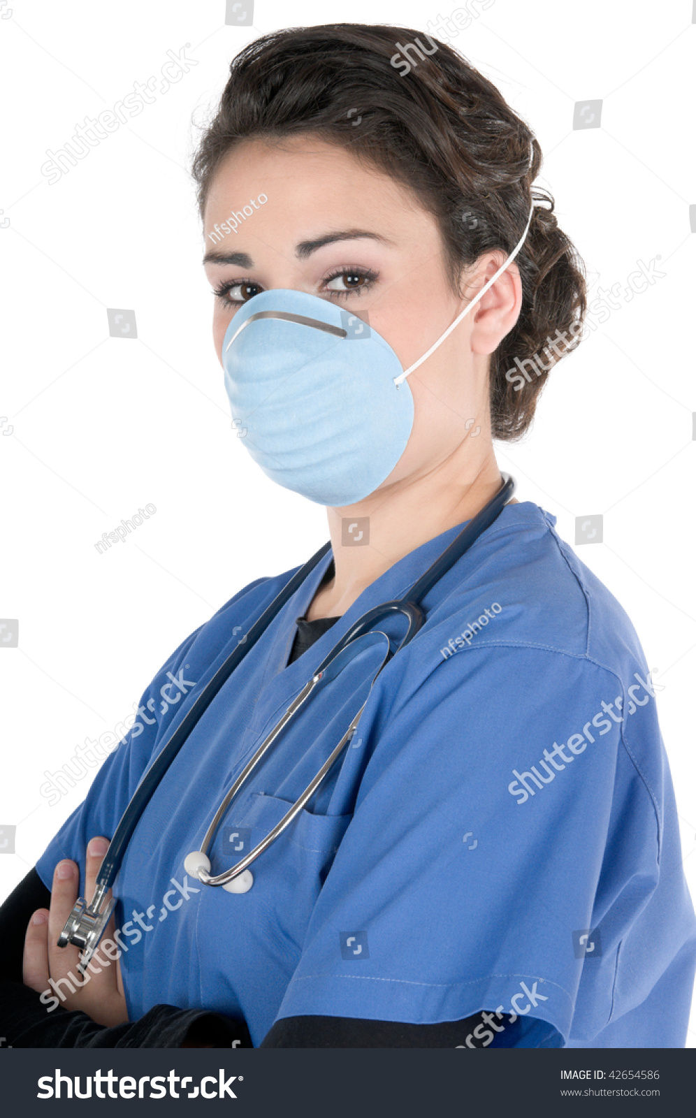 Young Female Nurse Wearing Blue Scrubs A Mask On Her Face As