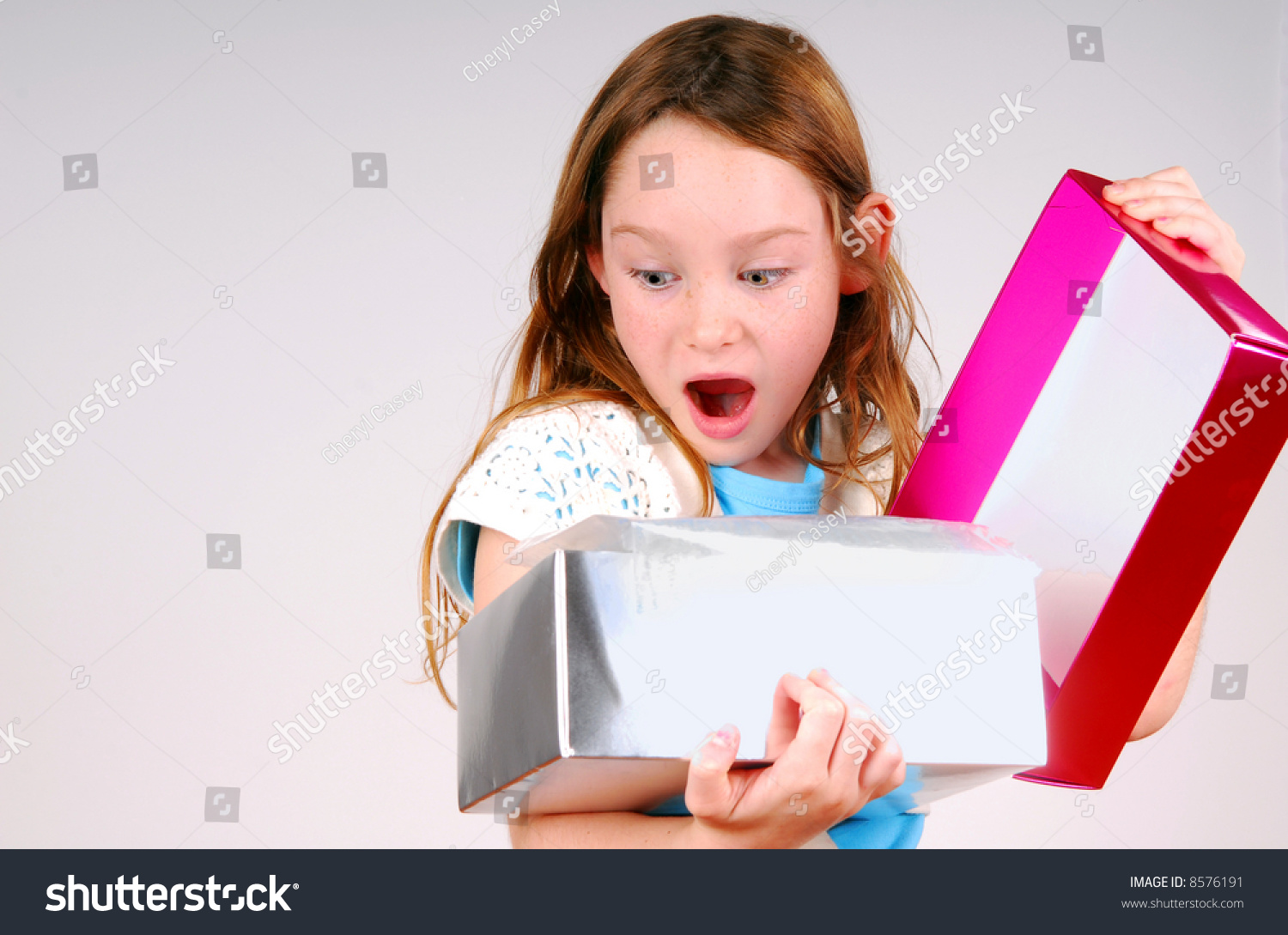 Young Girl Excited While Opening Gift Stock Photo 8576191 Shutterstock