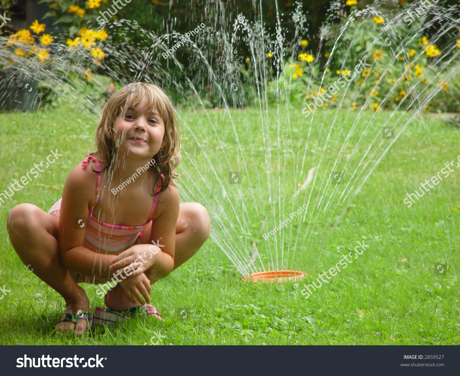 playing in sprinkler