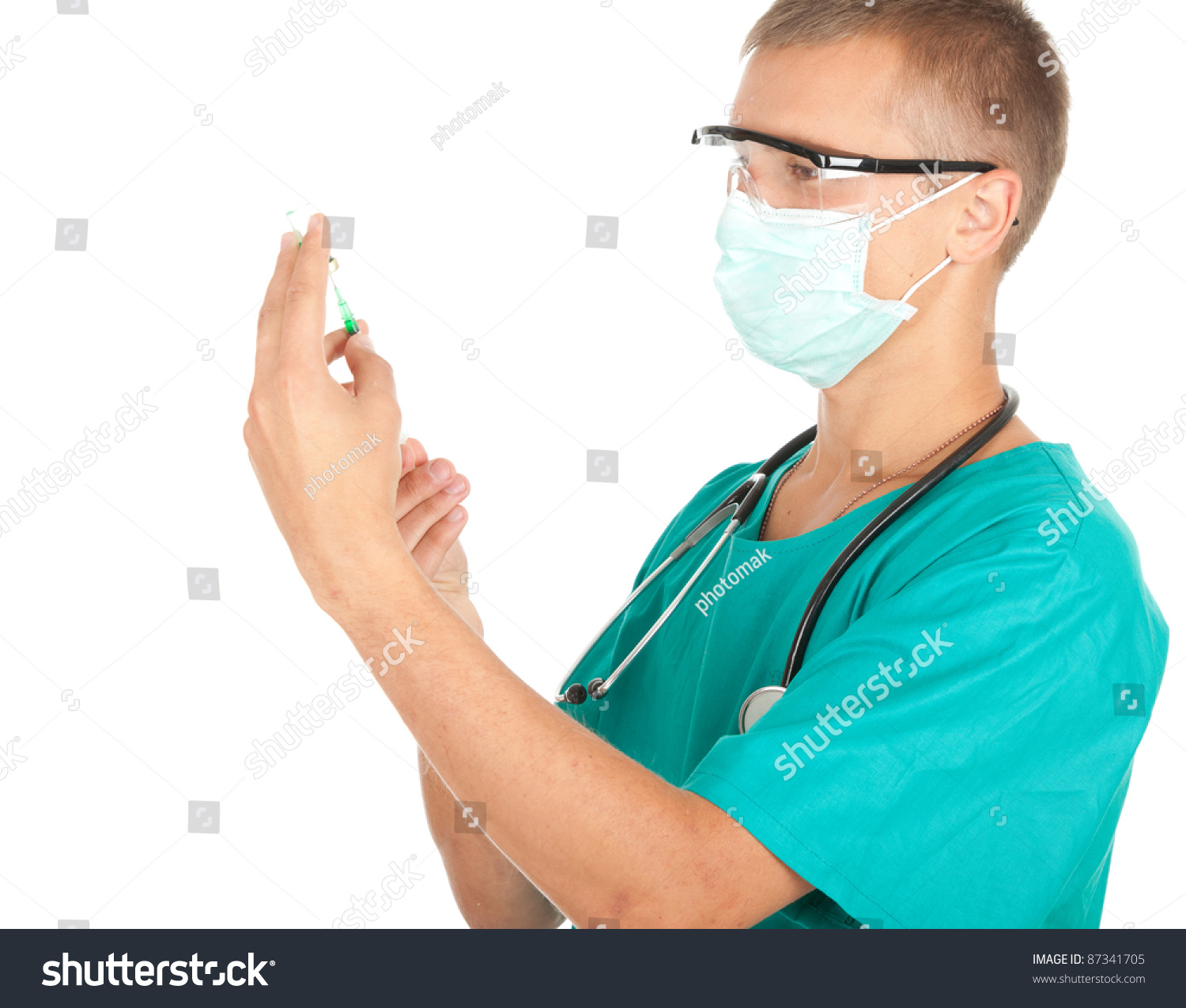 Young Male Doctor In Green Workwear And Medical Mask