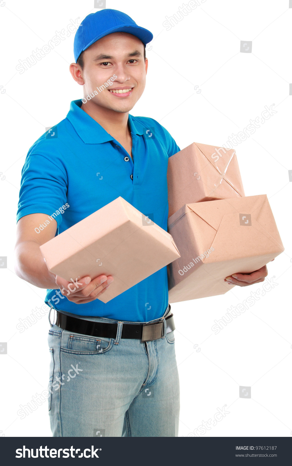 Young Man Courier In Blue Uniform With Packages Isolated On White Stock 