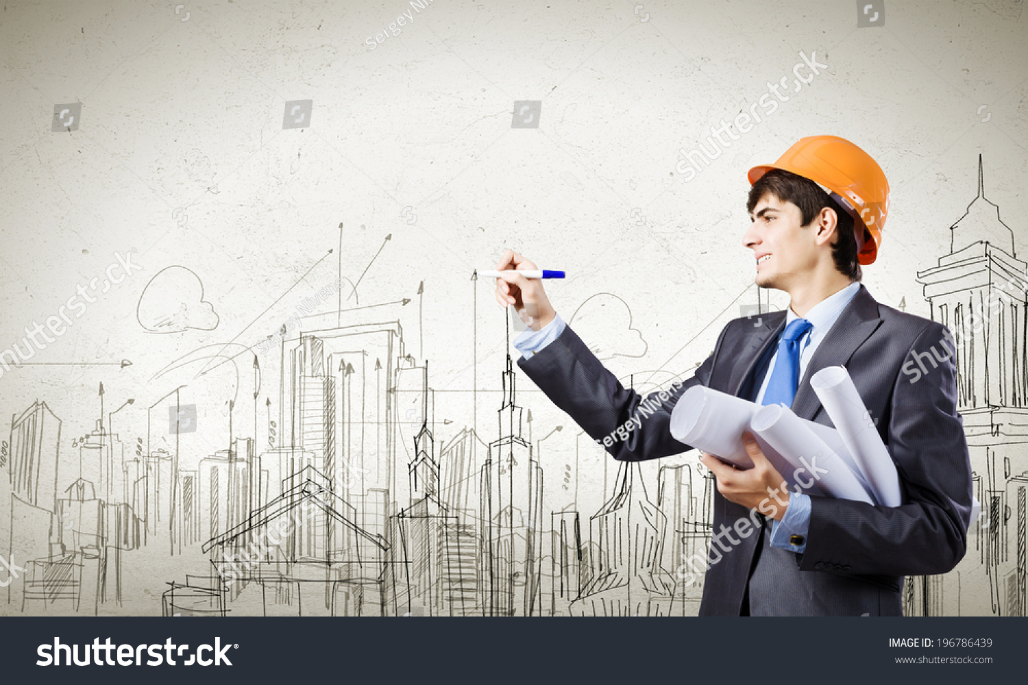 Young man engineer drawing sketches of construction project Young man engineer drawing sketches of construction project