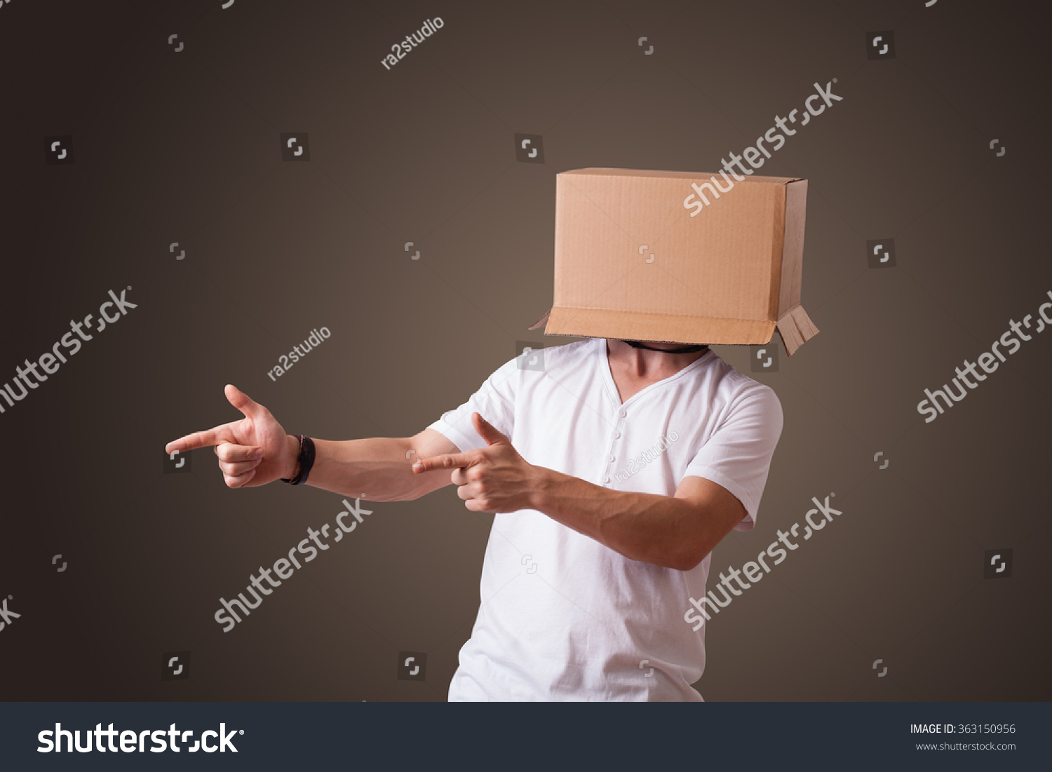 young-man-standing-and-gesturing-with-a-cardboard-box-on-his-head-stock