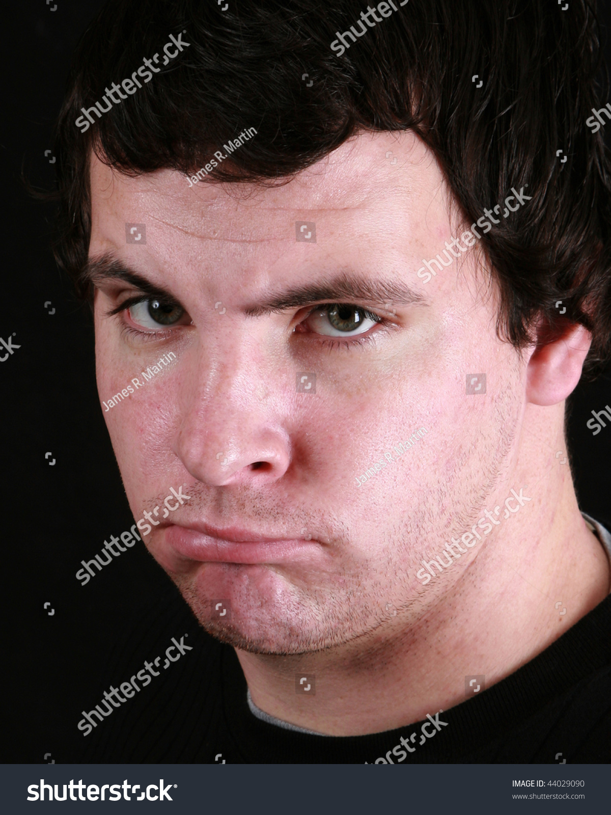 young-man-with-a-scowl-on-his-face-stock-photo-44029090-shutterstock