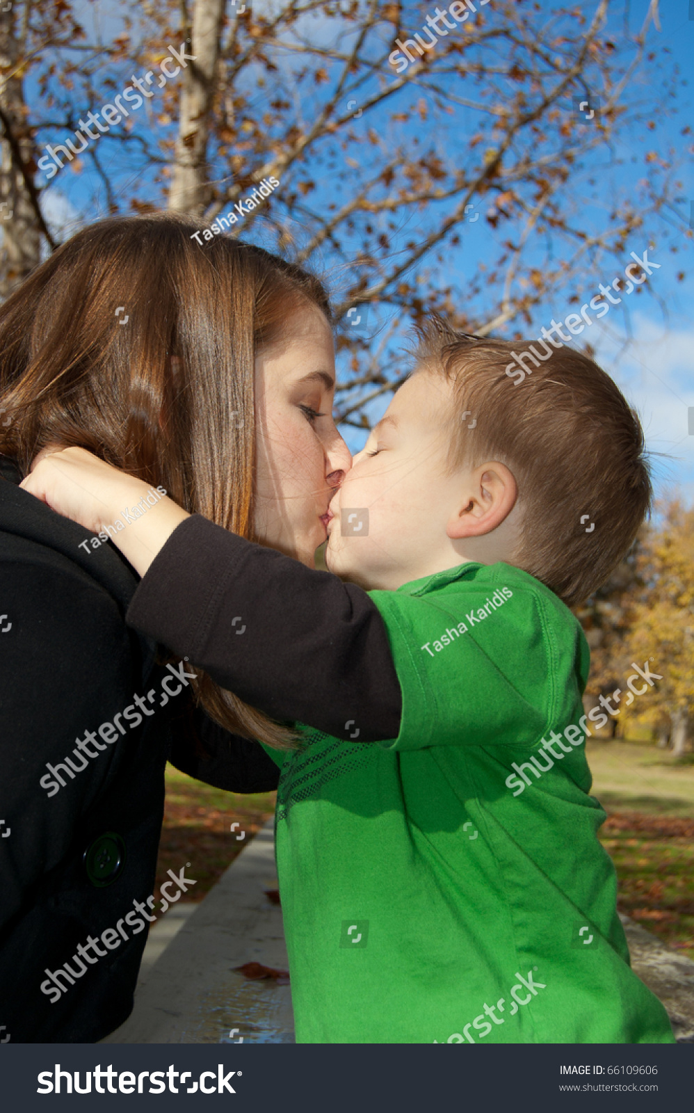 Young Mom And Son Giving Kis
