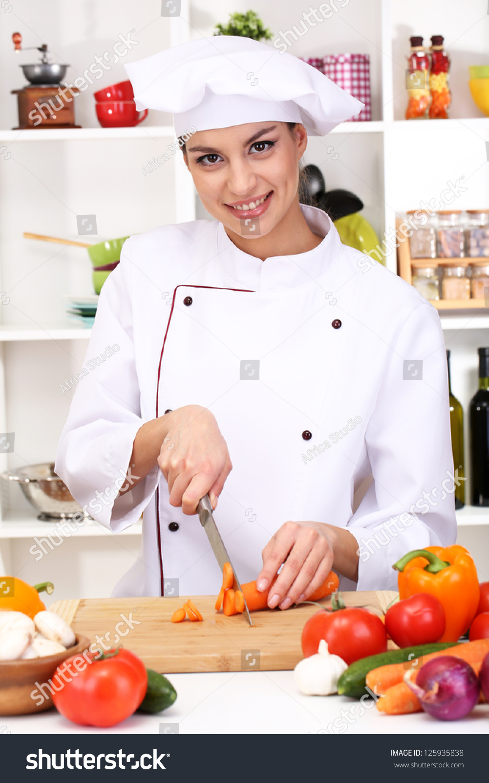 stock-photo-young-woman-chef-cooking-in-kitchen-125935838.jpg