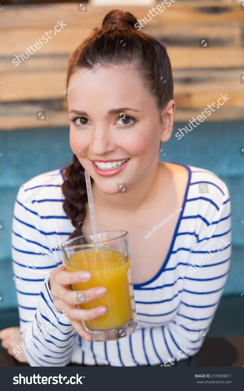 Young woman having glass of orange juice at the cafe Young woman having glass of orange juice at the cafe