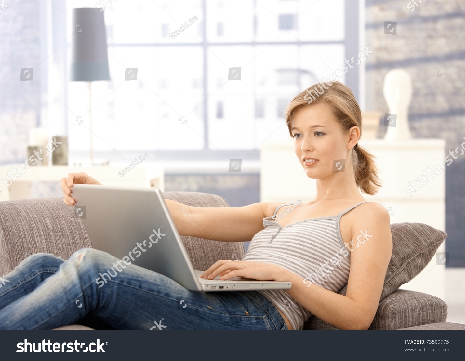 Lying On Sofa At Home Browsing On Lying On Sofa At Home Browsing On