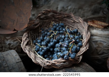 isolated clusters of grapes on wicker basket
