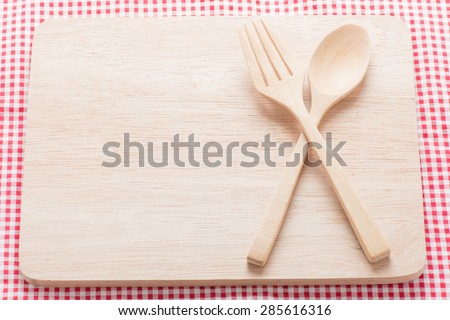 Wooden spoon on wooden cutting board