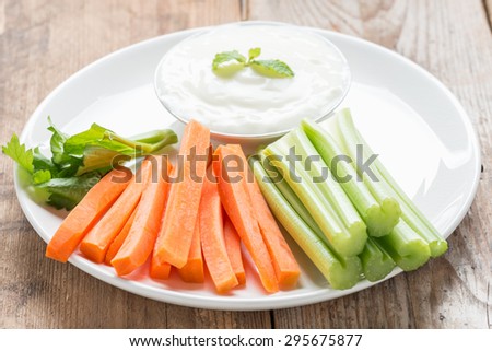 Vegetable sticks. Fresh celery and carrot with yogurt sauce.