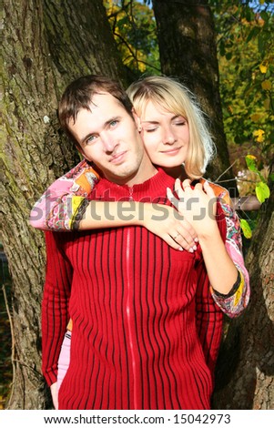 beautiful couple under the autumn three