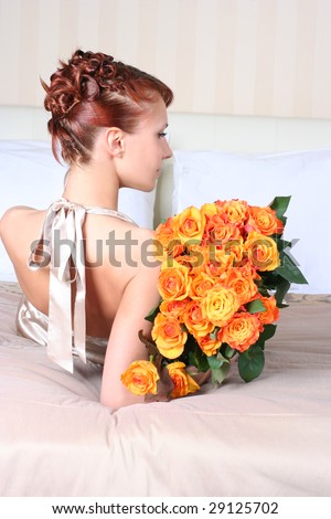beautiful young woman with bunch of roses