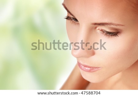beautiful young woman on green background