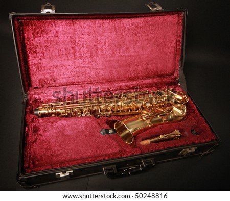 golden saxophone in black case