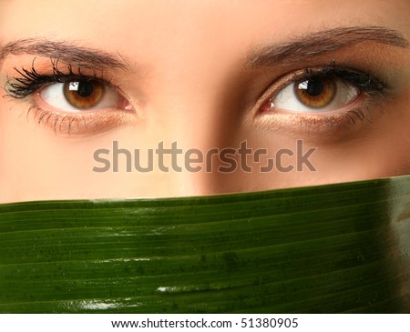close-up eyes and green leaf