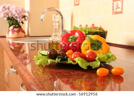 fresh vegetables and olive oil on a kitchen table