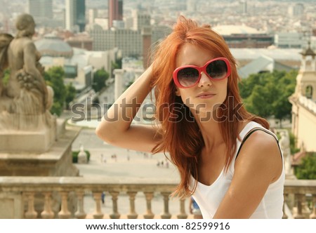 beautiful young woman looking over city