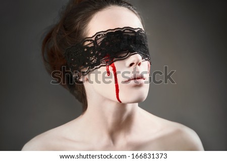 Portrait of a female vampire with black lace on her eyes