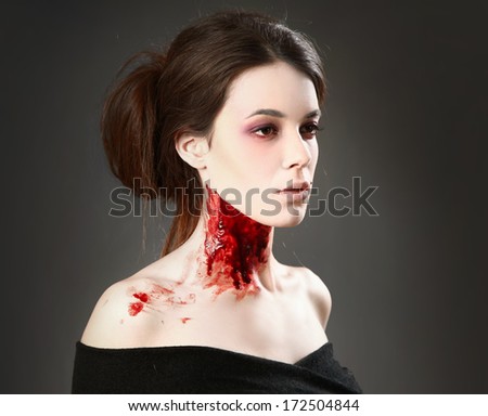 Portrait of a female vampire over black background