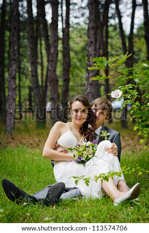 Groom and Bride in a park. wedding dress. Bridal wedding bouquet of flowers