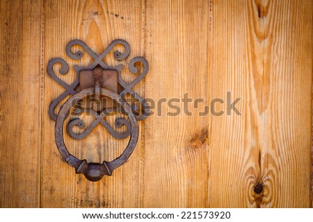The detail of an old large oak door with iron pull